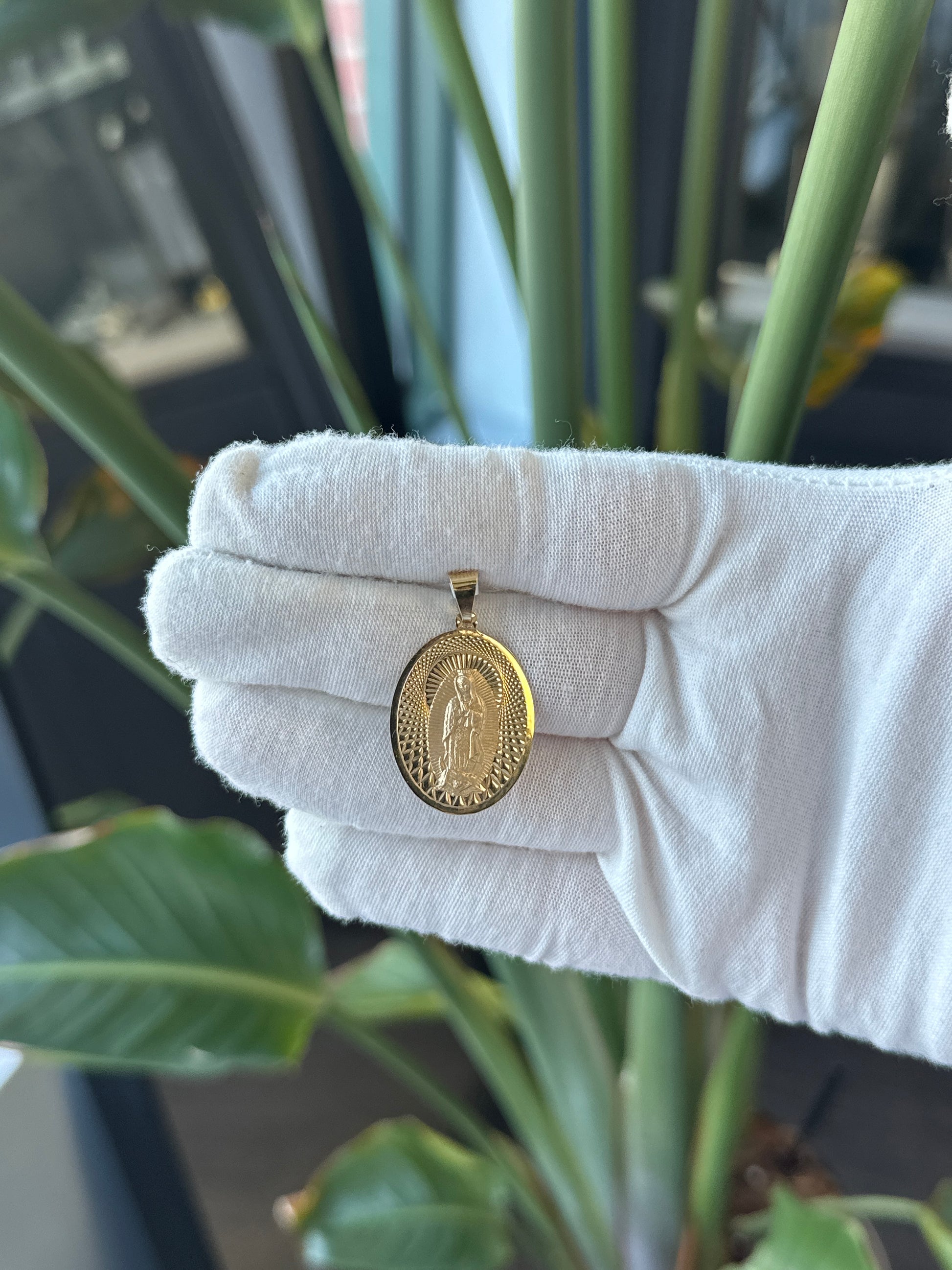 14k Yellow Gold Oval Virgin Mary Charm With Diamond Cut Details on Background - General Design Jewelers