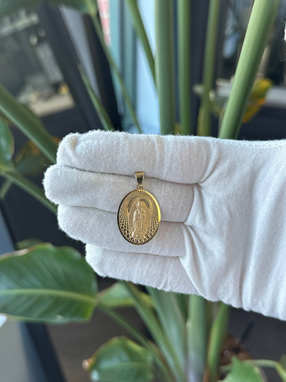 14k Yellow Gold Oval Virgin Mary Charm With Diamond Cut Details on Background - General Design Jewelers